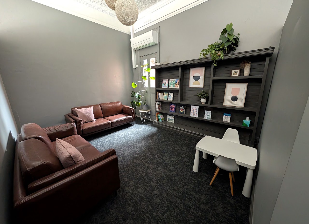 Camberwell’s quieter waiting area with leather sofas, bookshelves, plants and a child-sized table